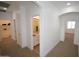 Bright hallway with bathroom view featuring dual sinks and neutral toned color scheme at 28377 N Desert Native St, San Tan Valley, AZ 85143