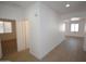 Clean hallway with hardwood flooring, neutral wall color, and bright light at 28377 N Desert Native St, San Tan Valley, AZ 85143
