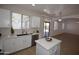 Bright kitchen with white cabinets, stainless steel appliances, and center island with a quartz countertop at 28377 N Desert Native St, San Tan Valley, AZ 85143