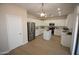 Kitchen with white cabinets, stainless appliances, quartz countertops, and wood-look flooring at 28377 N Desert Native St, San Tan Valley, AZ 85143