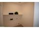 Bright laundry room with hookups and open shelving at 28377 N Desert Native St, San Tan Valley, AZ 85143