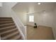 Well-lit living room featuring hardwood flooring, an open floor plan, a staircase, and ample natural light at 28377 N Desert Native St, San Tan Valley, AZ 85143