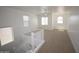 Bright loft space with carpet, neutral walls, ceiling fan, and several windows at 28377 N Desert Native St, San Tan Valley, AZ 85143