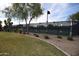 Well-maintained community tennis court surrounded by lush green spaces, promoting an active and healthy lifestyle for residents at 28377 N Desert Native St, San Tan Valley, AZ 85143