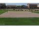 Sandy community volleyball court surrounded by green grass, perfect for active recreation and friendly neighborhood competition at 28377 N Desert Native St, San Tan Valley, AZ 85143