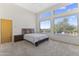 Bright bedroom with large windows offering views, complemented by a modern bed and neutral tones at 28729 N 107Th St, Scottsdale, AZ 85262