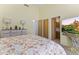Carpeted bedroom with a large bed and vanity at 28729 N 107Th St, Scottsdale, AZ 85262