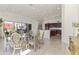 Dining room with glass table and chairs, open to kitchen with patio access at 28729 N 107Th St, Scottsdale, AZ 85262