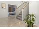 Bright entryway featuring tile floors, a staircase, and an entrance to the main bedroom at 28729 N 107Th St, Scottsdale, AZ 85262