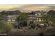 Desert home exterior boasts unique architecture, mature trees and desert landscape views at sunset at 28729 N 107Th St, Scottsdale, AZ 85262