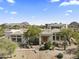 Desert home exterior features unique architecture, mature trees, desert landscape, and mountain views at 28729 N 107Th St, Scottsdale, AZ 85262