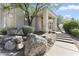 Desert home exterior featuring a stone pathway to the entry, natural desert landscaping, and mature trees at 28729 N 107Th St, Scottsdale, AZ 85262