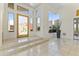Bright foyer with stone floors, glass doors, and windows providing ample natural light at 28729 N 107Th St, Scottsdale, AZ 85262