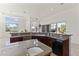 Beautiful kitchen showcasing a large island with a sink, dark wood cabinets, and ample natural light at 28729 N 107Th St, Scottsdale, AZ 85262