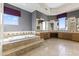 Large bathroom with a tub, dual sinks, vanity area, and travertine tile floors at 28729 N 107Th St, Scottsdale, AZ 85262