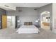 Spacious bedroom boasts neutral palette, plush carpet, and access to bathroom and dressing area at 28729 N 107Th St, Scottsdale, AZ 85262