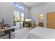 Bright bedroom features a walk-out to patio, work space, and an ensuite bathroom at 28729 N 107Th St, Scottsdale, AZ 85262