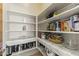 Well-organized pantry with ample shelving and patterned liners, perfect for storage and kitchen efficiency at 28729 N 107Th St, Scottsdale, AZ 85262