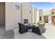 Inviting outdoor patio featuring comfortable seating, fireplace, and desert landscaping at 28729 N 107Th St, Scottsdale, AZ 85262