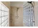 Tiled shower with multiple shower heads, glass block window, and stone accent at 28729 N 107Th St, Scottsdale, AZ 85262