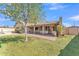 View of the backyard with mature trees, patio, pool and outdoor storage at 3046 E Dover St, Mesa, AZ 85213