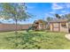 Backyard play area with swing set, slide, and storage shed on green grass at 3046 E Dover St, Mesa, AZ 85213