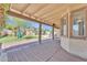Inviting covered patio overlooking lush green yard and playset at 3046 E Dover St, Mesa, AZ 85213