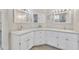 Bathroom with double sinks, white cabinetry, and ample counter space at 3046 E Dover St, Mesa, AZ 85213