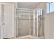 Bathroom featuring glass enclosed corner shower with tile surround and shower head at 3046 E Dover St, Mesa, AZ 85213
