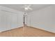 Bright bedroom featuring wood-look flooring and closet with white doors at 3046 E Dover St, Mesa, AZ 85213