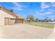 Exterior shot showcasing a spacious driveway and a two-car garage on a corner lot at 3046 E Dover St, Mesa, AZ 85213