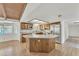 Bright kitchen area with a central island, stainless steel appliances, and warm wood cabinetry at 3046 E Dover St, Mesa, AZ 85213