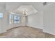 Bright living room featuring tile flooring and a large bay window with plantation shutters at 3046 E Dover St, Mesa, AZ 85213
