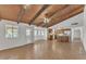 Open-concept living area connects kitchen and gathering spaces, featuring exposed ceiling beams at 3046 E Dover St, Mesa, AZ 85213