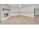 Spacious living room with a unique stone fireplace and neutral tile flooring at 3046 E Dover St, Mesa, AZ 85213