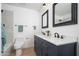 Bathroom with updated vanity featuring dual sinks with modern fixtures and dark wood cabinets at 3307 W Mescal St, Phoenix, AZ 85029