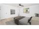 Bright bedroom features a ceiling fan, a modern window, and minimalist decor at 3307 W Mescal St, Phoenix, AZ 85029