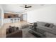 Open floor plan with a living room featuring modern furniture, sleek ceiling fan, and wood-style floors at 3307 W Mescal St, Phoenix, AZ 85029