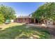 Spacious backyard featuring a covered patio and mature trees at 3538 W Sierra Vista Dr, Phoenix, AZ 85019