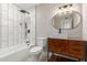 Well-lit bathroom with modern vanity, tub and shower, and tile backsplash at 3538 W Sierra Vista Dr, Phoenix, AZ 85019