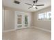 Bright bedroom featuring wood-look floors, ceiling fan, and access to outdoor living space at 3538 W Sierra Vista Dr, Phoenix, AZ 85019