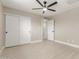 Neutral bedroom with wood-look floors, closet, and ensuite bathroom at 3538 W Sierra Vista Dr, Phoenix, AZ 85019
