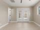 Well-lit bedroom with wood-look floors, ceiling fan, and access to outdoor area at 3538 W Sierra Vista Dr, Phoenix, AZ 85019