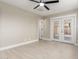 Bright bedroom with wood-look floors and ceiling fan featuring backyard access at 3538 W Sierra Vista Dr, Phoenix, AZ 85019