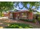 Charming brick home featuring mature trees and updated front windows at 3538 W Sierra Vista Dr, Phoenix, AZ 85019