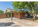 Home featuring a covered parking area with additional driveway space and brick siding at 3538 W Sierra Vista Dr, Phoenix, AZ 85019