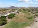 Community aerial view with golf course, mountain views and houses with private pools at 4002 N San Gabriel Cir, Mesa, AZ 85215