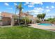 The home features a lush lawn and private pool, perfect for outdoor living and entertaining at 4002 N San Gabriel Cir, Mesa, AZ 85215