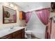 Bathroom featuring a shower with purple curtain, a sink with vanity, and a toilet at 4002 N San Gabriel Cir, Mesa, AZ 85215