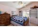 Cozy bedroom features a custom bookshelf, bright window and a blue patchwork quilt at 4002 N San Gabriel Cir, Mesa, AZ 85215